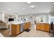 Spacious kitchen with stainless steel appliances, marble countertops, and seamless flow to dining and living spaces at 8652 Se 133Rd Ln, Summerfield, FL 34491