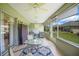 Relaxing screened lanai with stylish furniture, a ceiling fan, and serene views of the lush green yard at 8652 Se 133Rd Ln, Summerfield, FL 34491