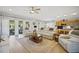 Bright and airy living room featuring neutral tones, comfortable seating, and large windows at 8652 Se 133Rd Ln, Summerfield, FL 34491