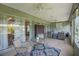 Relaxing screened-in patio with comfortable seating and views of the backyard at 8652 Se 133Rd Ln, Summerfield, FL 34491