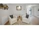 Cozy sitting room with two armchairs, neutral walls and a modern decor at 8652 Se 133Rd Ln, Summerfield, FL 34491