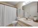 Functional bathroom featuring a shower with curtain, toilet, and vanity with sink and large mirror at 8712 Sw 92Nd Pl # D, Ocala, FL 34481