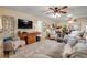Open living room with neutral colors, hardwood floors, and a view into the dining area at 8712 Sw 92Nd Pl # D, Ocala, FL 34481