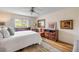 Comfortable main bedroom with large window, ceiling fan, and vinyl floors at 8712 Sw 92Nd Pl # D, Ocala, FL 34481