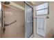 Accessible walk-in shower with safety bar and tiled walls at 8712 Sw 92Nd Pl # D, Ocala, FL 34481