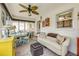 Bright sunroom showcasing a dining table set, comfortable sofa, and natural light through large windows at 8712 Sw 92Nd Pl # D, Ocala, FL 34481