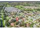 Aerial view pinpoints the house in a neighborhood near the golf course at 8980 Se 178Th Muirfield Pl, The Villages, FL 32162