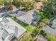 Aerial view of the house featuring a screen lanai and lush backyard at 8980 Se 178Th Muirfield Pl, The Villages, FL 32162