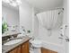 Bright bathroom boasts a granite vanity, shower-tub combo and decor at 8980 Se 178Th Muirfield Pl, The Villages, FL 32162