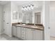 Bathroom features double sinks, granite counters, and ample lighting at 8980 Se 178Th Muirfield Pl, The Villages, FL 32162