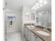 Bathroom features double sinks, granite counters, and ample lighting at 8980 Se 178Th Muirfield Pl, The Villages, FL 32162