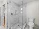 Modern bathroom featuring a glass shower with tiled walls and floors at 8980 Se 178Th Muirfield Pl, The Villages, FL 32162