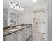 Bathroom features double sinks, granite counters, and ample lighting at 8980 Se 178Th Muirfield Pl, The Villages, FL 32162