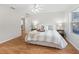 Bright bedroom features wood floors, neutral walls, and a ceiling fan for comfortable living at 8980 Se 178Th Muirfield Pl, The Villages, FL 32162