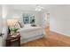 Bright bedroom features a window, neutral colors, and an ensuite at 8980 Se 178Th Muirfield Pl, The Villages, FL 32162