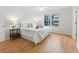Bright bedroom features wood floors, neutral walls, and a ceiling fan for comfortable living at 8980 Se 178Th Muirfield Pl, The Villages, FL 32162
