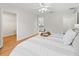 Bright bedroom features wood floors, neutral walls, and a ceiling fan for comfortable living at 8980 Se 178Th Muirfield Pl, The Villages, FL 32162