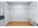 Walk-in closet features wood floors and installed shelving for organized storage at 8980 Se 178Th Muirfield Pl, The Villages, FL 32162