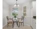 Eat-in kitchen dining nook featuring a glass table and views to yard at 8980 Se 178Th Muirfield Pl, The Villages, FL 32162