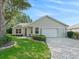 Charming single story home featuring landscaped yard, paved driveway, and attached two car garage at 8980 Se 178Th Muirfield Pl, The Villages, FL 32162