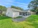 Exterior of home offering a screened-in patio and lush landscaping at 8980 Se 178Th Muirfield Pl, The Villages, FL 32162