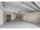 Spacious garage offering updated ceiling mechanics and grey epoxy floors at 8980 Se 178Th Muirfield Pl, The Villages, FL 32162