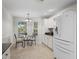 Bright kitchen with white cabinets, modern appliances, and dining nook at 8980 Se 178Th Muirfield Pl, The Villages, FL 32162