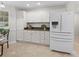 Kitchen with white cabinetry, granite countertops, and stainless steel appliances at 8980 Se 178Th Muirfield Pl, The Villages, FL 32162