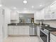 Updated kitchen with white cabinets, stainless appliances, and a modern design at 8980 Se 178Th Muirfield Pl, The Villages, FL 32162