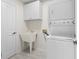 Functional laundry room with washer, dryer, utility sink, and storage cabinet at 8980 Se 178Th Muirfield Pl, The Villages, FL 32162