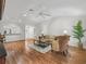 Bright living room featuring wood floors, a ceiling fan, vaulted ceilings, and stylish furnishings at 8980 Se 178Th Muirfield Pl, The Villages, FL 32162