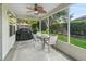 Screened patio with a ceiling fan, dining table and a grill at 8980 Se 178Th Muirfield Pl, The Villages, FL 32162