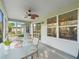 Screened patio features a ceiling fan, glass table and outdoor seating at 8980 Se 178Th Muirfield Pl, The Villages, FL 32162