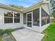 Exterior view of the screened in patio accessible by a sliding glass door at 8980 Se 178Th Muirfield Pl, The Villages, FL 32162