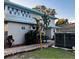 Backyard with an above ground hot tub, lush landscaping, and stone pavers leading to the house at 101 S Dixie Ave, Fruitland Park, FL 34731