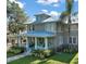 Charming two-story home featuring a welcoming front porch and beautifully landscaped front yard with a metal roof at 101 S Dixie Ave, Fruitland Park, FL 34731