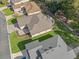 Aerial view of a house with a well-manicured lawn and mature landscaping at 10994 Se 168Th Loop, Summerfield, FL 34491