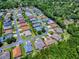Aerial view of a neighborhood community with homes and tree lined streets at 10994 Se 168Th Loop, Summerfield, FL 34491