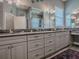 A spacious bathroom offers double sinks, granite counters, and coastal accents at 10994 Se 168Th Loop, Summerfield, FL 34491