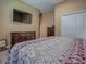 Bedroom showcasing wood furnishings, closet, and warm color palette at 10994 Se 168Th Loop, Summerfield, FL 34491