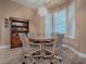 Dining area with wood table, upholstered chairs, and shelving unit at 10994 Se 168Th Loop, Summerfield, FL 34491