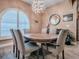 Elegant dining room with a large chandelier, window, and six chairs at 10994 Se 168Th Loop, Summerfield, FL 34491