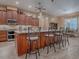 Spacious kitchen features large island with seating, stainless appliances and wood cabinetry at 10994 Se 168Th Loop, Summerfield, FL 34491
