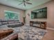 Relaxing living room with comfortable sectional sofa, fireplace and large screen television at 10994 Se 168Th Loop, Summerfield, FL 34491