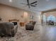 Open-concept living area features a stone fireplace, wood-look tile, furniture, and dining area at 10994 Se 168Th Loop, Summerfield, FL 34491