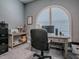 This office boasts an arched window, modern desk, and ample workspace at 10994 Se 168Th Loop, Summerfield, FL 34491