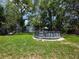 Lush backyard featuring a well-maintained lawn and an above ground pool perfect for summer fun at 1104 Flamingo Dr, Leesburg, FL 34748