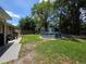Backyard offering a lawn, patio area, privacy fence and an above ground pool for outdoor enjoyment at 1104 Flamingo Dr, Leesburg, FL 34748