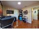 Bedroom with a large wall-mounted TV, tiled floor and natural light from the window at 1104 Flamingo Dr, Leesburg, FL 34748