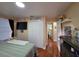 Comfortable bedroom featuring closet, tiled floor, wall-mounted television and access to the bathroom at 1104 Flamingo Dr, Leesburg, FL 34748